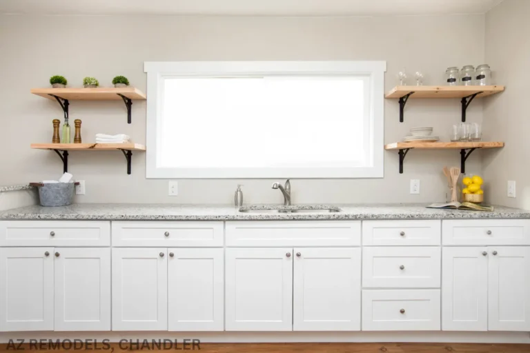 A view of kitchen with white cabinets