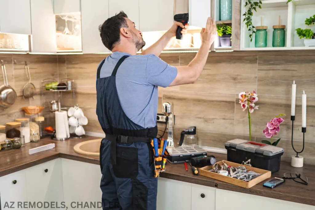 Man installing cabinet in modern kitchen.